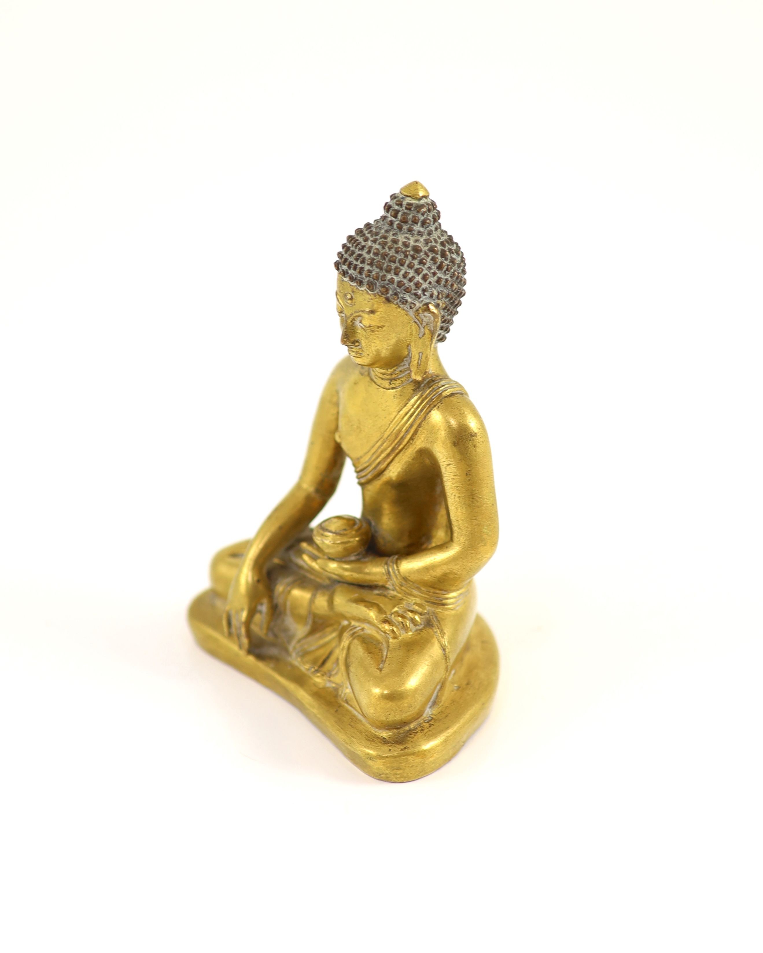 A Tibetan gilt copper alloy seated figure of Buddha Shakyamuni, 18th century, 13cm high